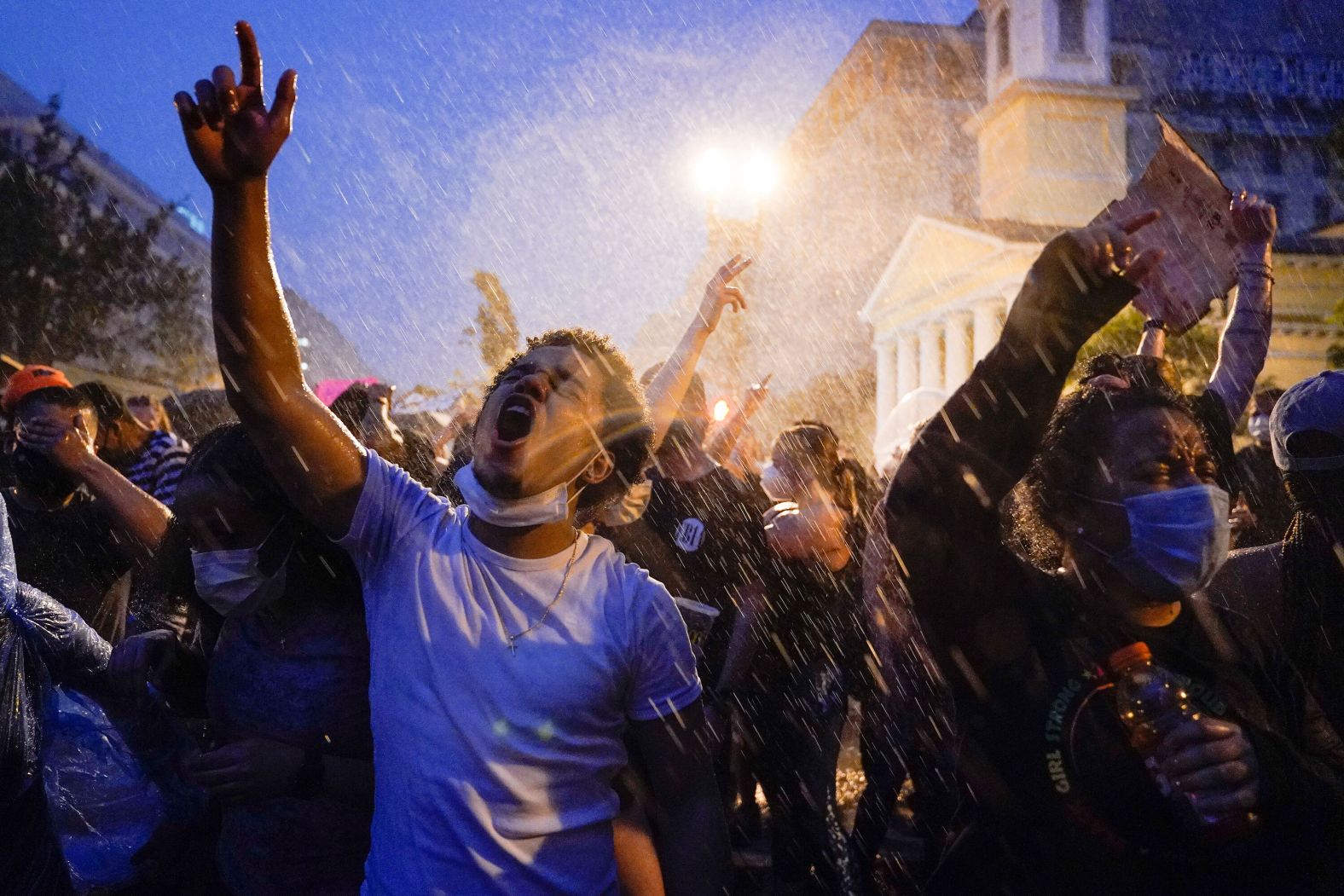 Demonstrators brave the rain to protest near the White House on June 4.