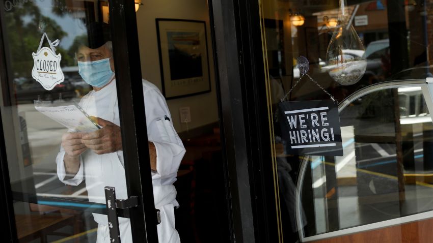A "We're Hiring" sign advertising jobs is seen at the entrance of a restaurant, as Miami-Dade County eases some of the lockdown measures put in place during the coronavirus disease (COVID-19) outbreak, in Miami, Florida, U.S., May 18, 2020. Photo by Marco Bello/Reuters
