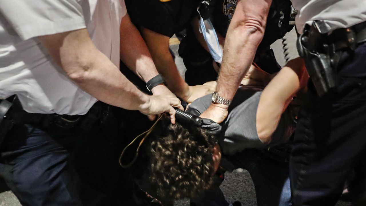 Police arrest a protester on Fifth Avenue during a march in Manhattan.