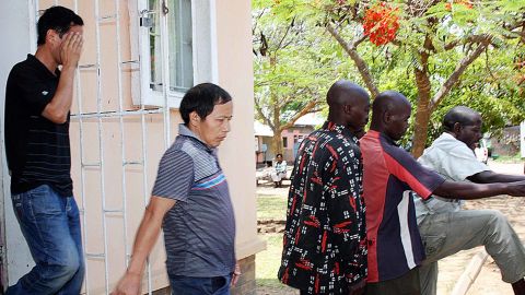 Wu Jiu Hua (L) and Xiao Li Shan (C), the two Chinese managers alleged to have shot 12 workers at Collum coal mine, leave the Choma Magistrate Court with other Zambian suspects on November 2, 2010 in Sinazongwe. 