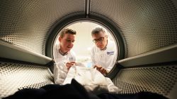 PHD student Max Kelly, 24 and marine microbiologist Professor J Grant Burgess both from Newcastle University check clothing in a washing machine at the Benton Proctor and Gamble site in Newcastle, during research into the release of microfibres using different washing cycles. (Photo by Owen Humphreys/PA Images via Getty Images)