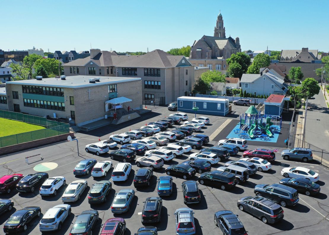 Parishioners attend Sunday morning Mass from their cars in the parking lot at the Parish of Saint Agnes Cathedral on May 31, 2020, in Rockville Centre, New York. 