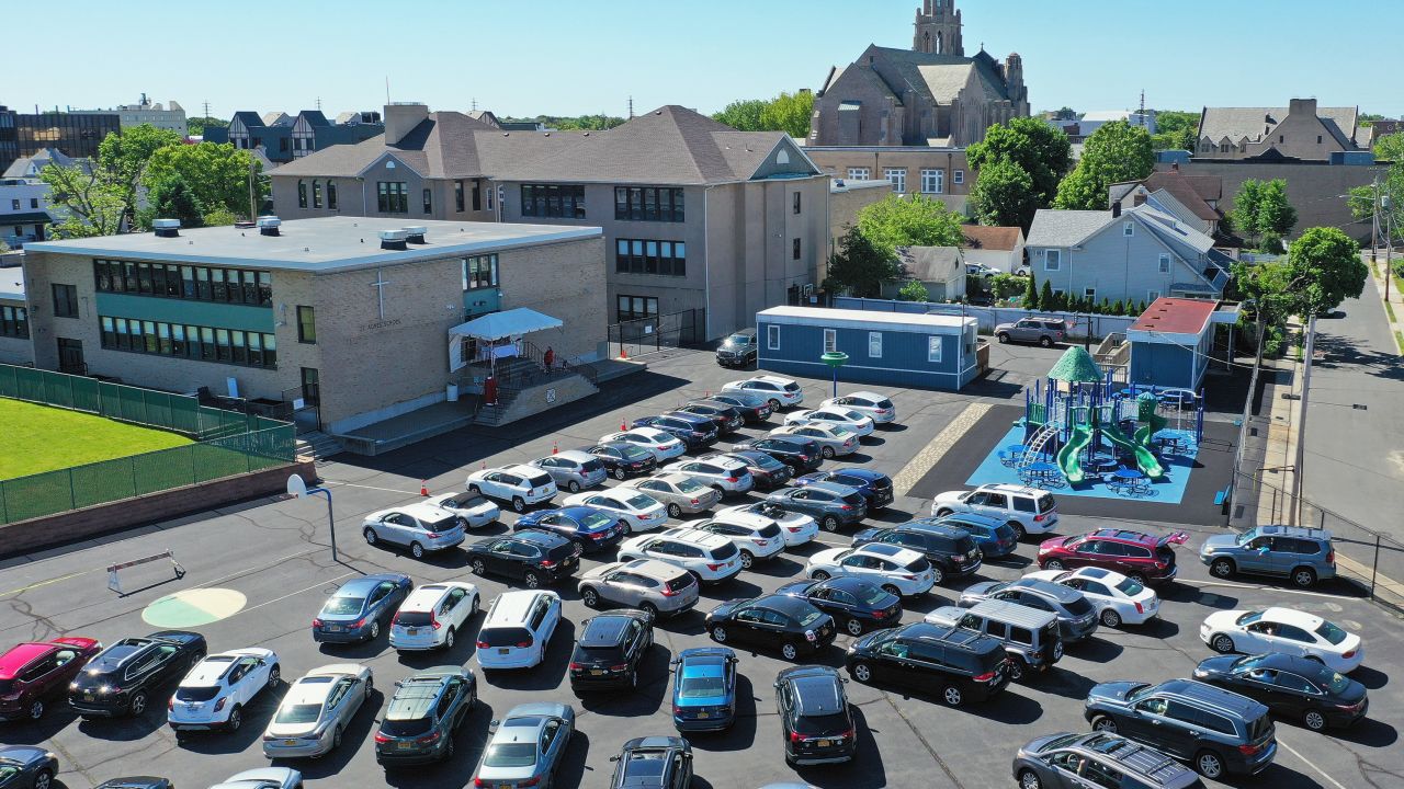 Parishioners attend Sunday morning Mass from their cars in the parking lot at the Parish of Saint Agnes Cathedral on May 31, 2020, in Rockville Centre, New York.