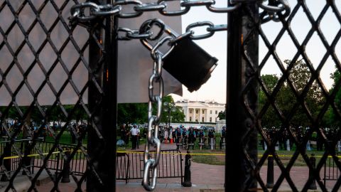 A locked padlock keeps a metal fence recently erected in front of the White House and meant to keep protestors at bay closed on June 2, 2020. (Photo by ROBERTO SCHMIDT/AFP via Getty Images)