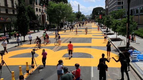 The street leading to the White House is painted with the words Black Lives Matter by city workers and activists Friday, June 5, 2020. (AP Photo/Manuel Balce Ceneta)