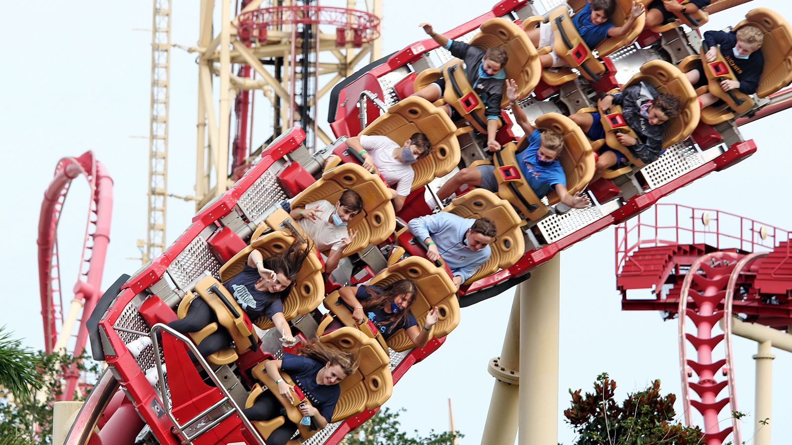 Visitors ride a roller coaster at the Universal Studios theme park in Orlando after it reopened on June 5.