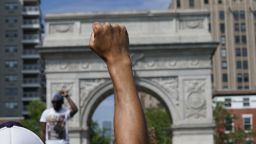 A demonstrator raises his fist in Washington square protesting the death of George Floyd, who died in police custody, on June 3, 2020 in New York. - Derek Chauvin, the white Minneapolis police officer who kneeled on the neck of George Floyd, a black man who later died, will now be charged with second-degree murder, and his three colleagues will also face charges, court documents revealed on June 3. The May 25 death of George Floyd -- who had been accused of trying to buy cigarettes with a counterfeit bill -- has ignited protests across the United States over systemic racism and police brutality. (Photo by Timothy A. Clary/AFP/Getty Images)