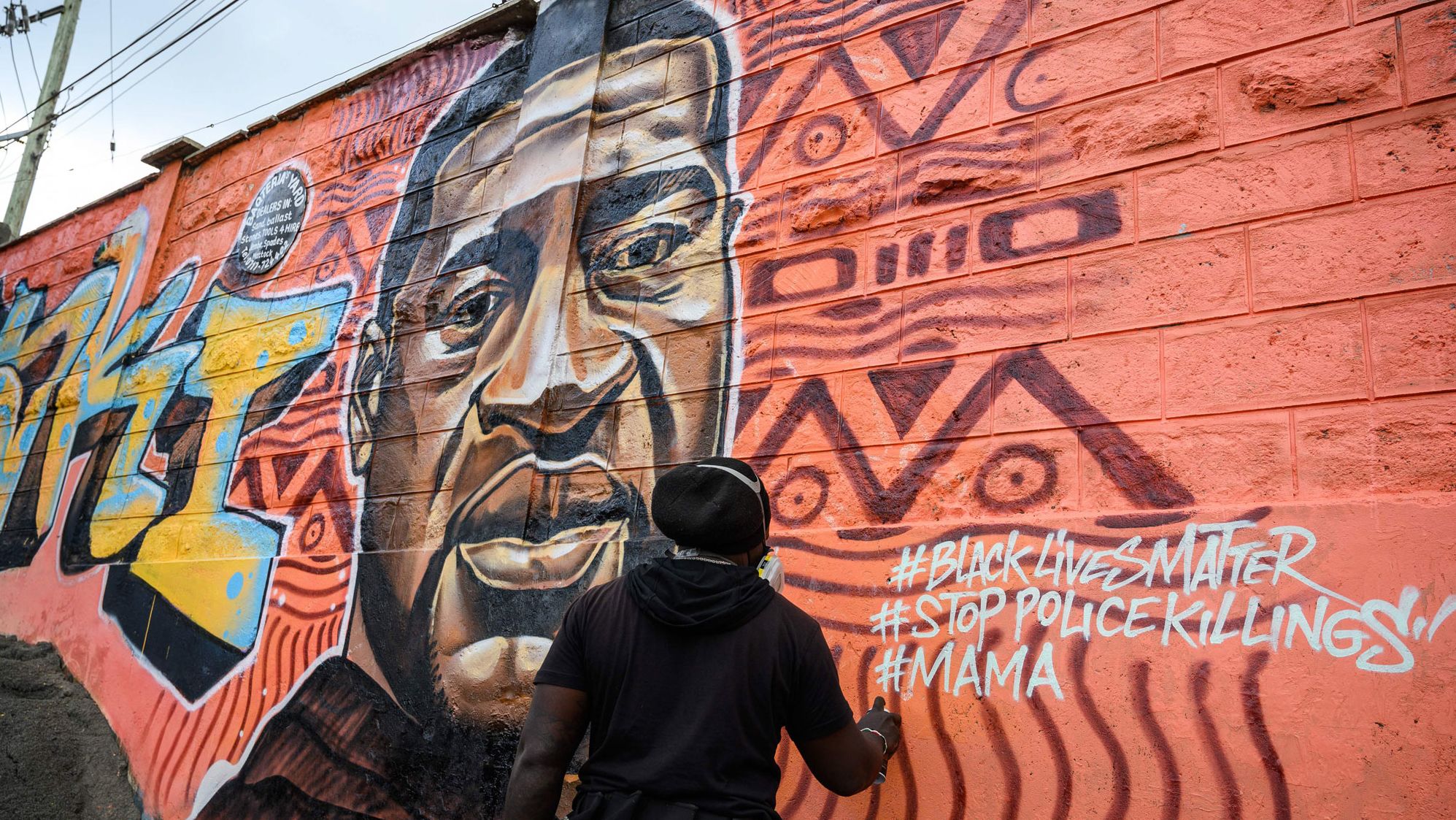 Allan Mwangi, also known as Mr.detail.seven, works on a mural in the Kibera slum of Nairobi, Kenya, on June 3.