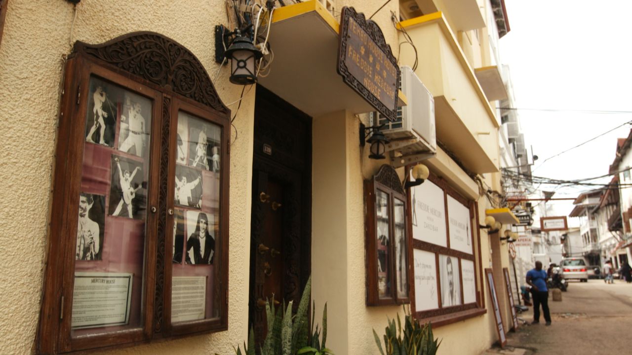 Photos of Freddie Mercury performing with Queen hang outside the museum in Zanzibar's Stone Town neighborhood.