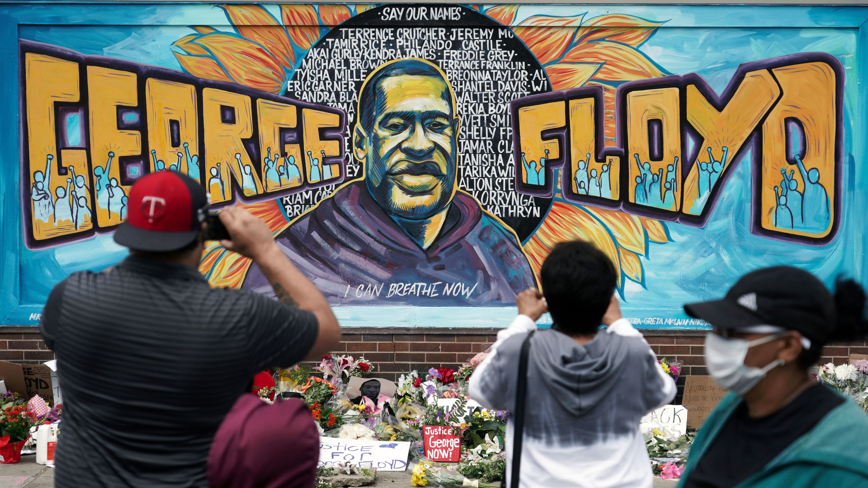 People gather at a George Floyd mural in Minneapolis on May 29. <a href="https://www.cnn.com/style/article/george-floyd-mural-social-justice-art/index.html" target="_blank">The mural</a> was painted by Greta McLain, Xena Goldman and Cadex Herrera at the spot where Floyd was killed.