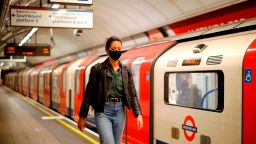 A commuter wears a facemask as she disembarks at a tube station in London on June 5, as lockdown measures are eased.