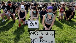 Demonstrators get down on their knees during a moment of silence for George Floyd during a Black Lives Matter protest in Buffalo Grove, Illinois, on Thursday, June 4.