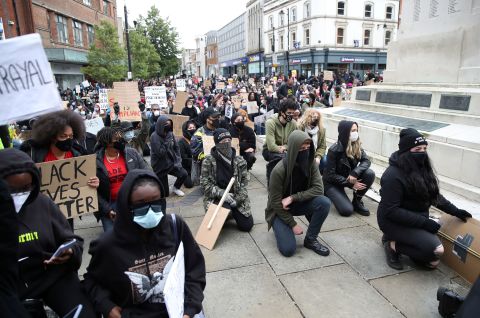 Demonstrators take a knee in Luton, England.