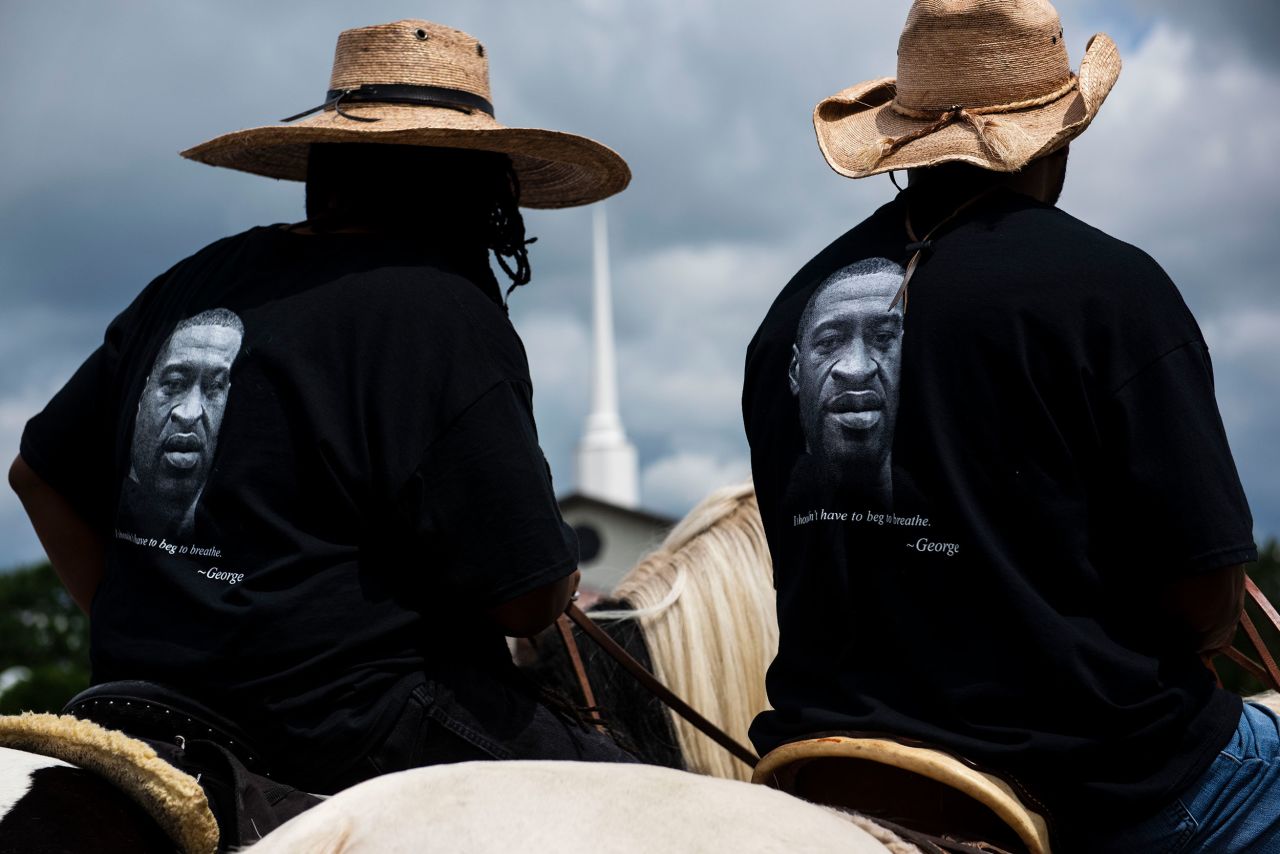 Members of a local Black Cowboys club ride their horses through the parking lot outside a Floyd memorial service in Raeford, North Carolina, on Saturday.