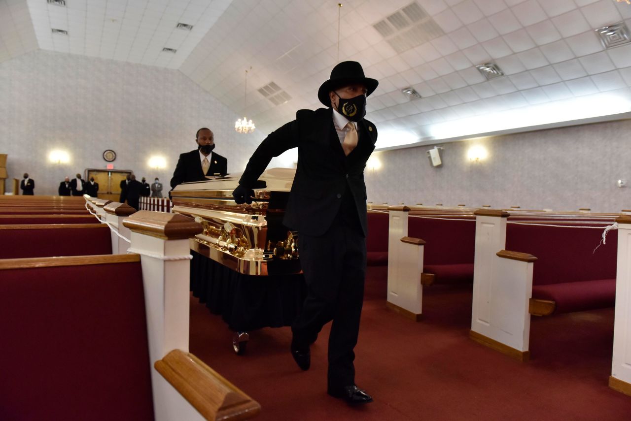 Floyd's casket is brought into a church ahead of his memorial service in Raeford.