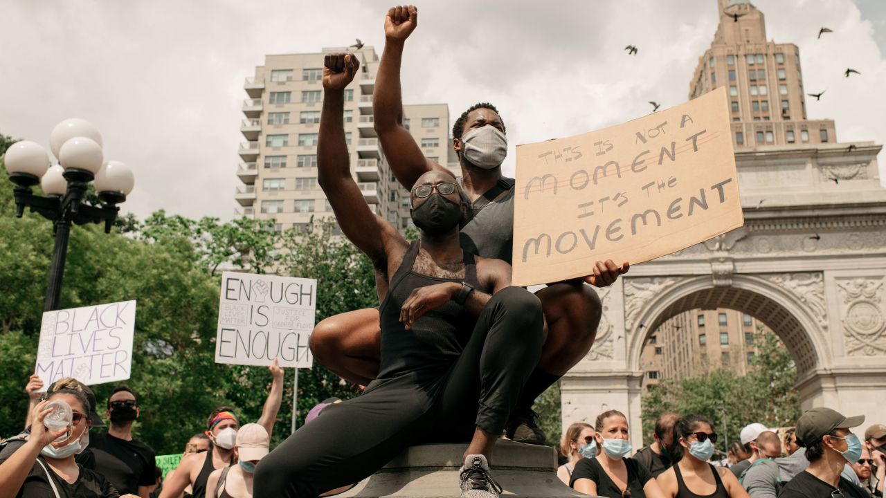 Demonstrators wear masks as they denounce systemic racism and the police killings of black Americans in Washington Square Park in the borough of Manhattan on June 6, 2020 in New York City.