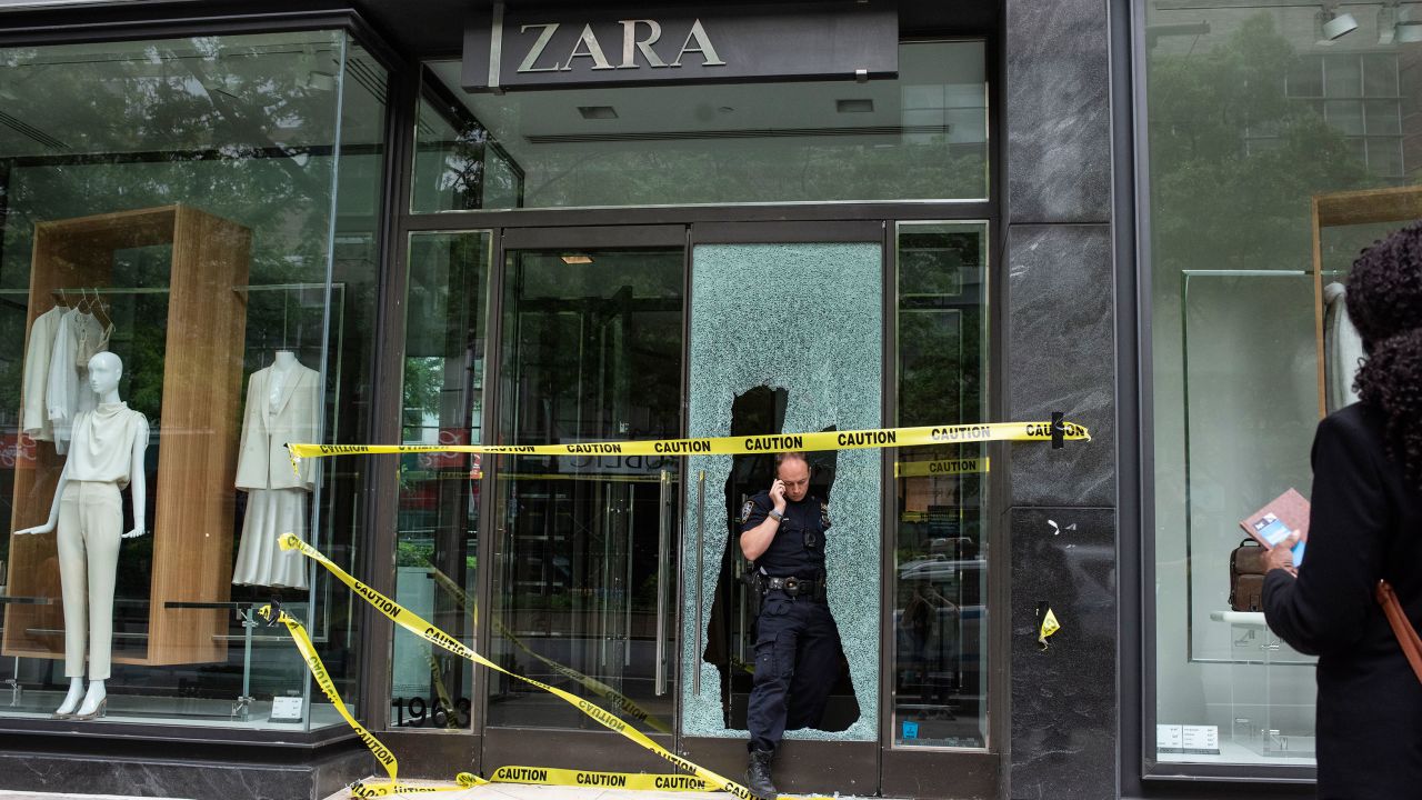 A police officer leaves  a Zara store that was looted the night before on June 1 in New York City. 