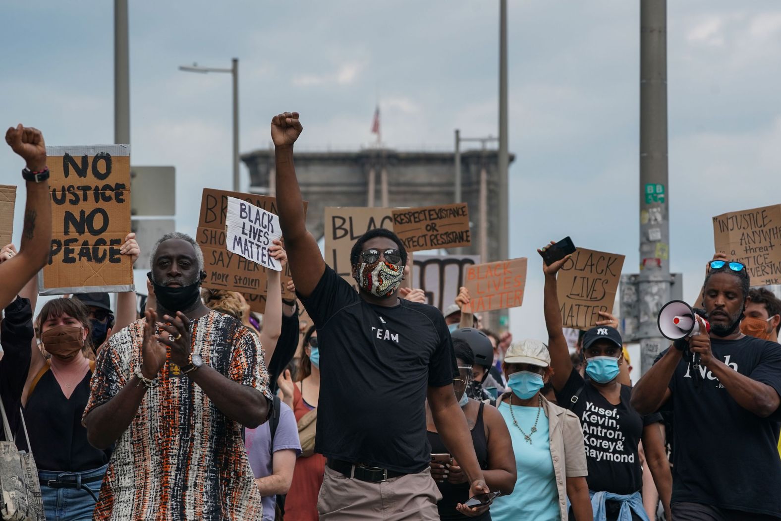 Protesters walk across the Brooklyn Bridge in New York on June 6.