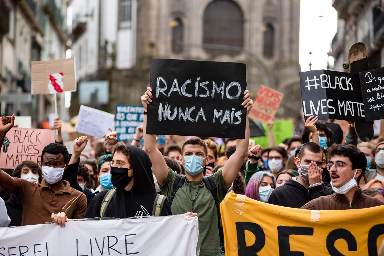 Protesters hold signs denouncing racism during a demonstration in Porto, Portugal, on June 7. 
