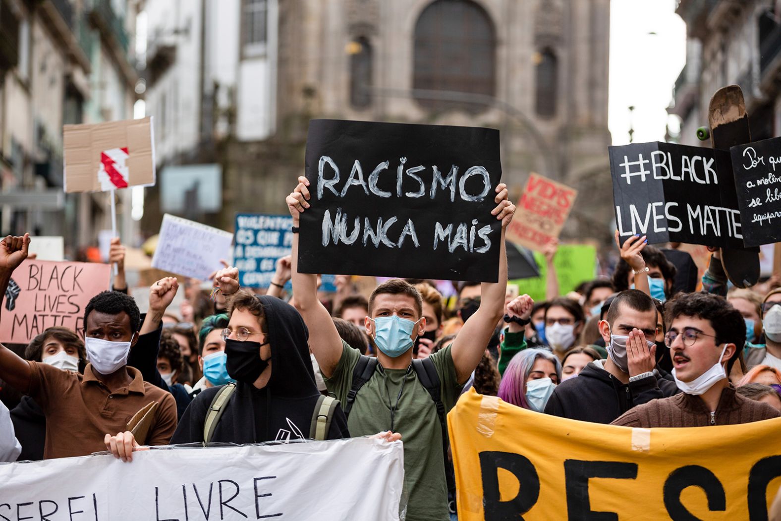 Protesters hold signs denouncing racism during a demonstration in Porto, Portugal, on June 7.