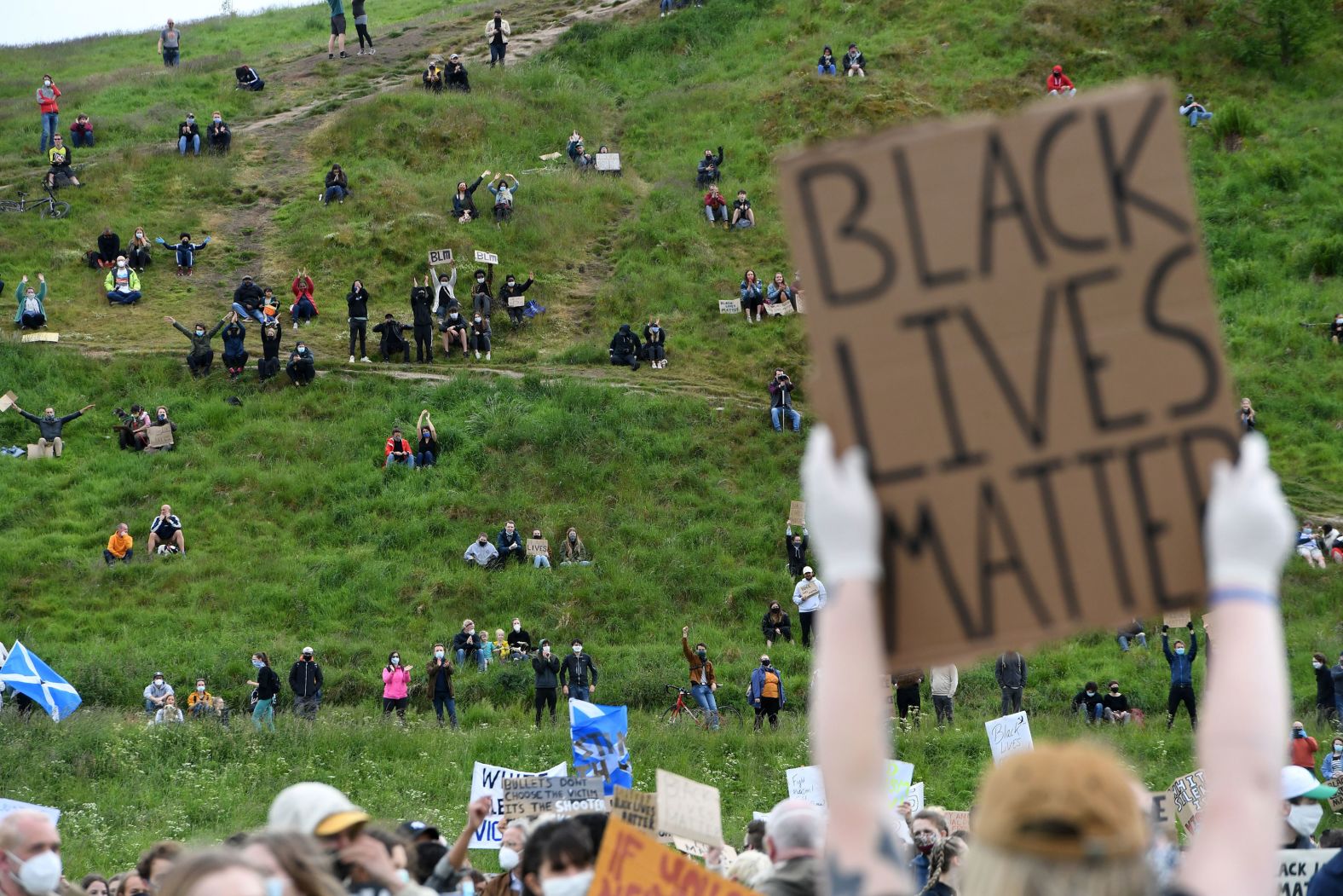 A protester holds up a sign at a demonstration in Edinburgh, Scotland, on June 7.