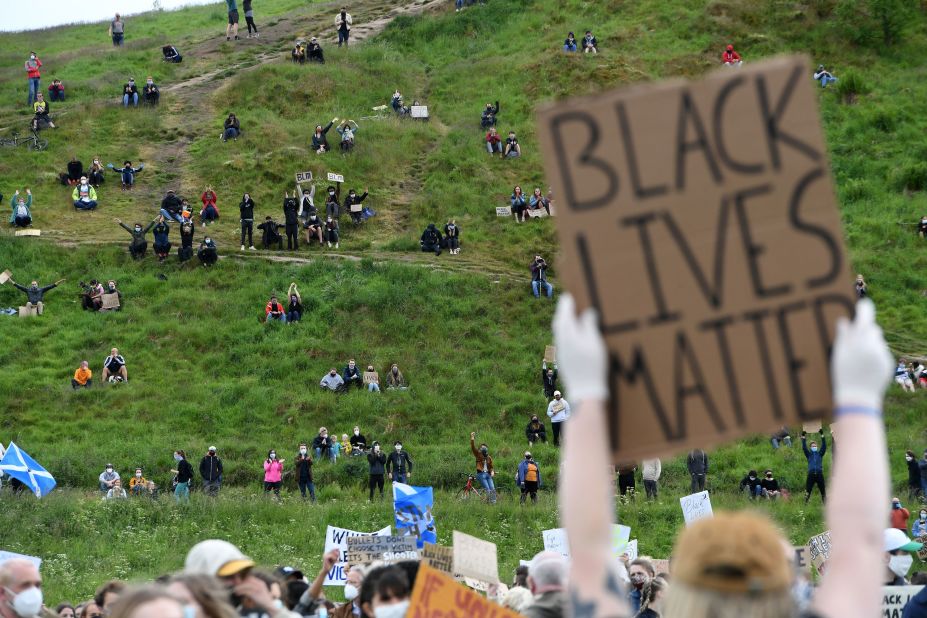A protester holds up a sign at a demonstration in Edinburgh, Scotland, on June 7.