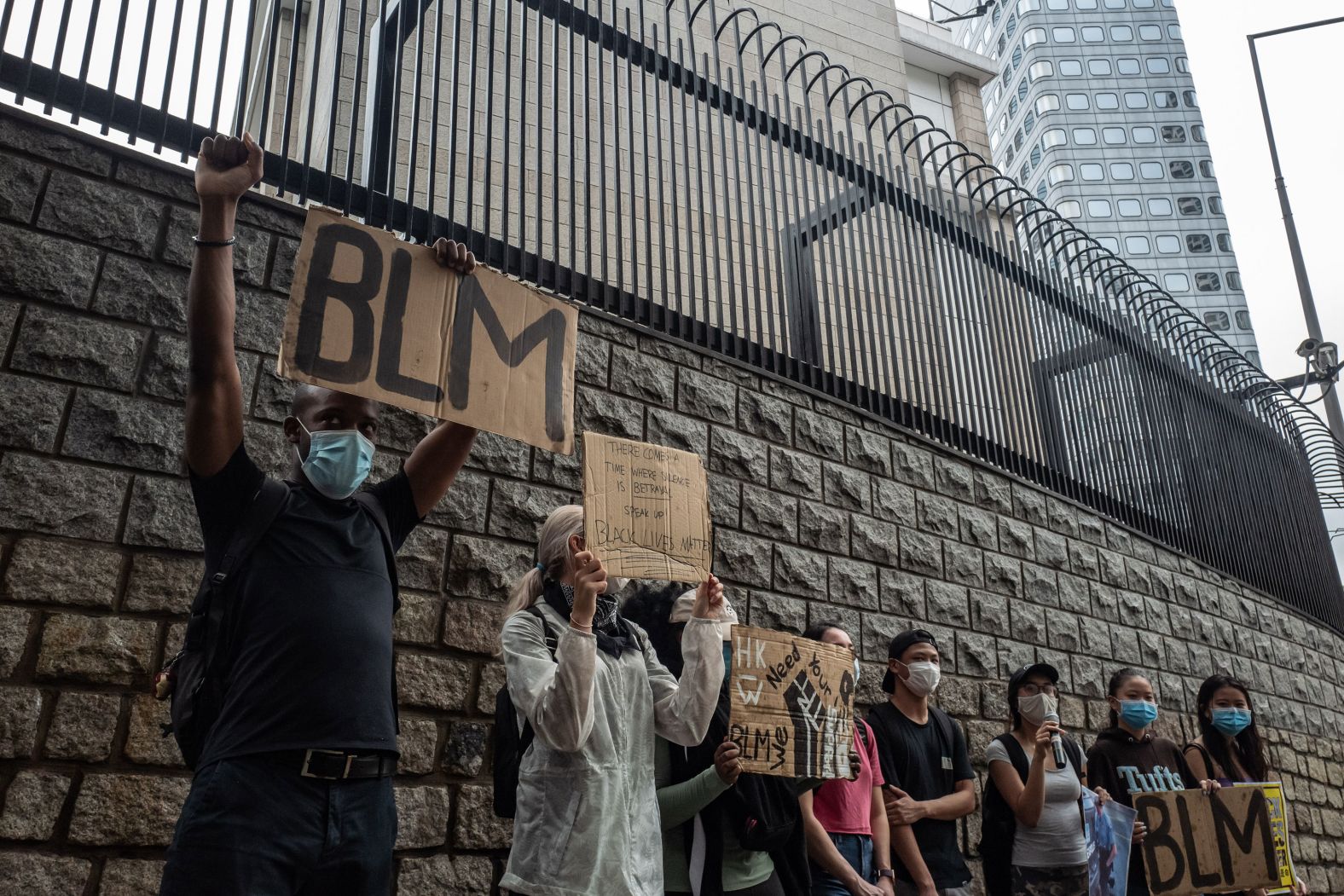 Participants hold signs during a rally outside of the Consulate General of the United States in Hong Kong on June 7.