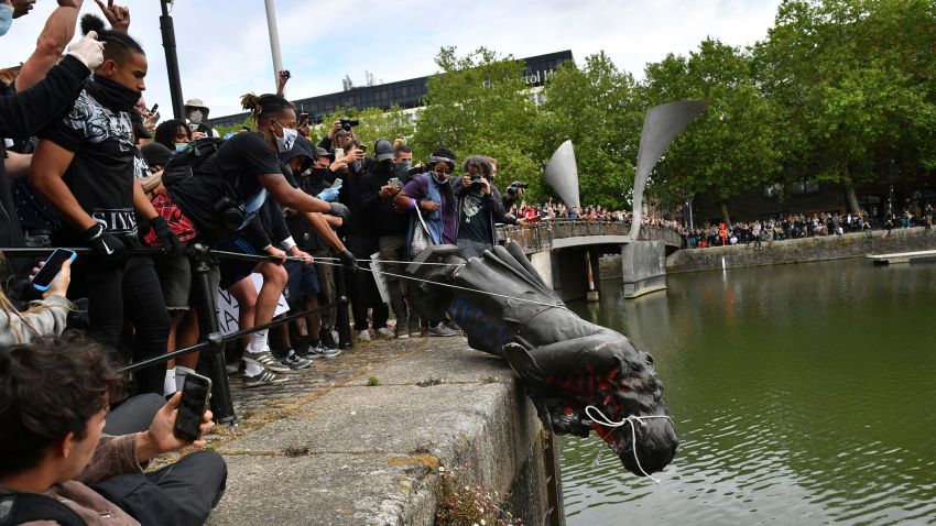 Black Lives Matter protests. Protesters throw statue of Edward Colston into Bristol harbour during a Black Lives Matter protest rally, in memory of George Floyd who was killed on May 25 while in police custody in the US city of Minneapolis. Picture date: Sunday June 7, 2020. See PA story POLICE Floyd. Photo credit should read: Ben Birchall/PA Wire URN:54052046 (Press Association via AP Images)