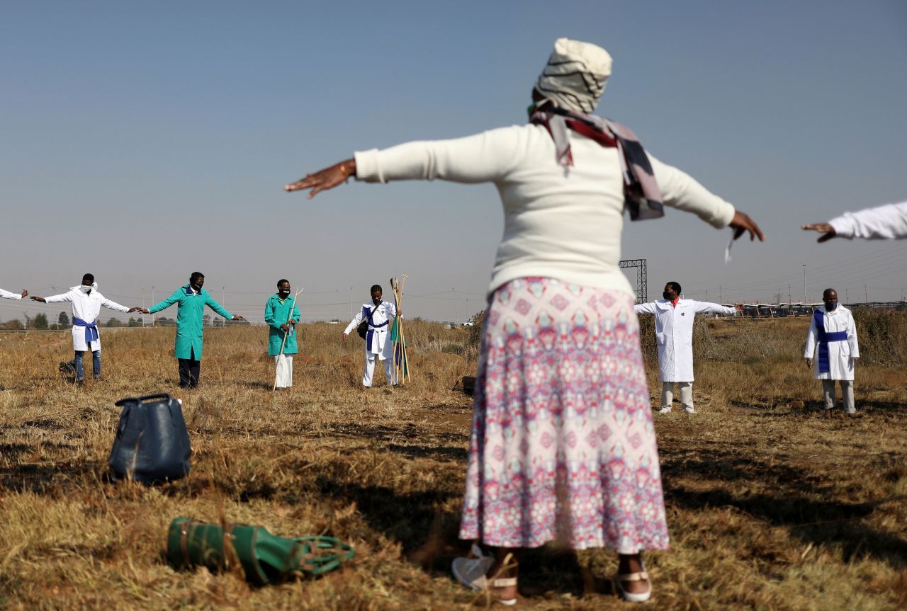 Congregants of the Inhlanhla Yokuphila Apostolic Church In Zion practice social distancing as they attend a service in an open field in Soweto, South Africa, on June 7.