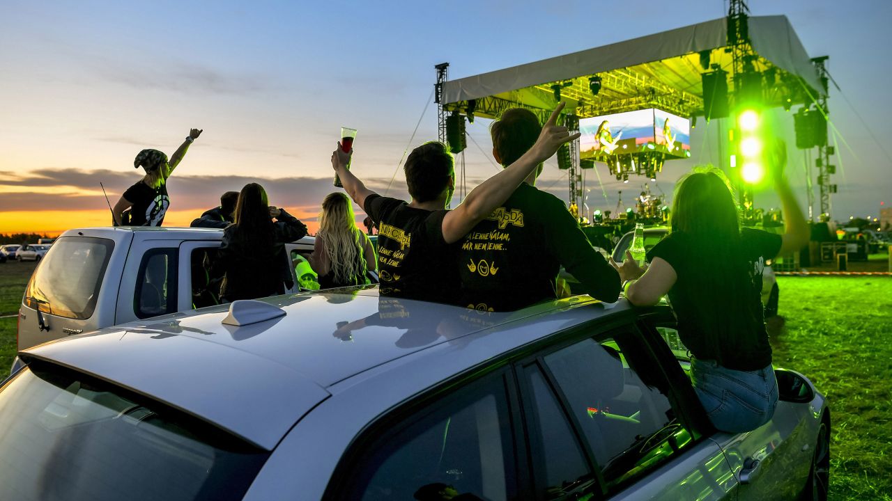 People attend a drive-in concert at the international airport in Debrecen, Hungary, on May 29.