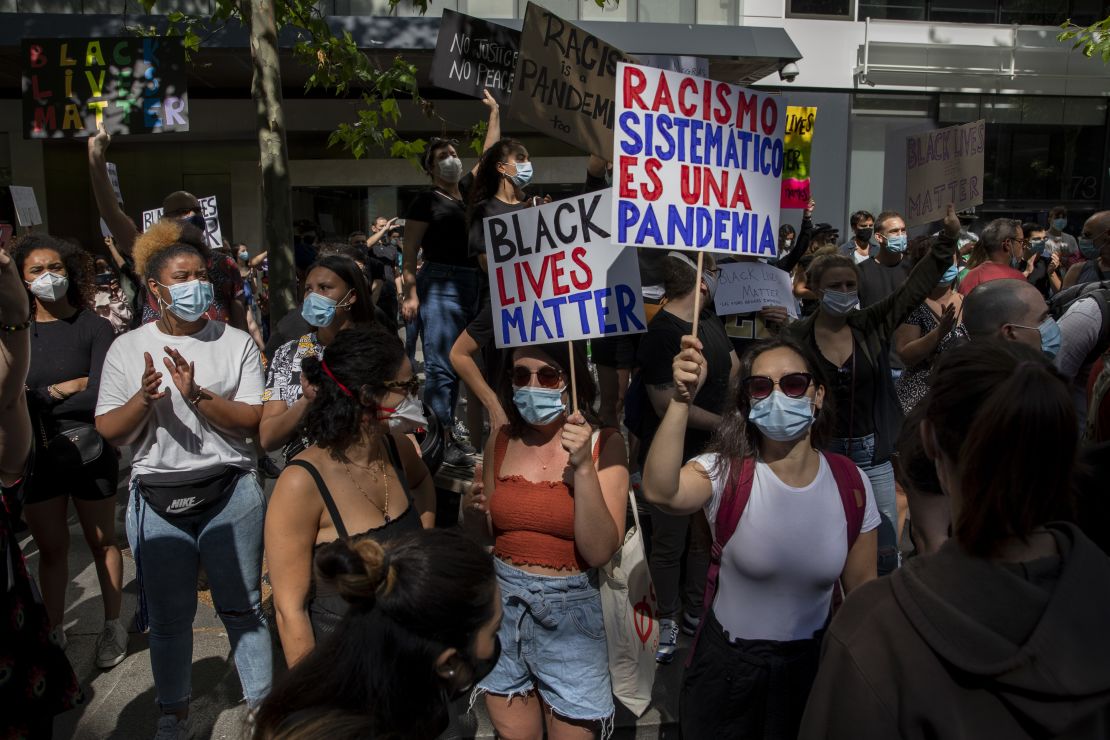 In Madrid, a protester warns that "Systemic racism is a pandemic." 