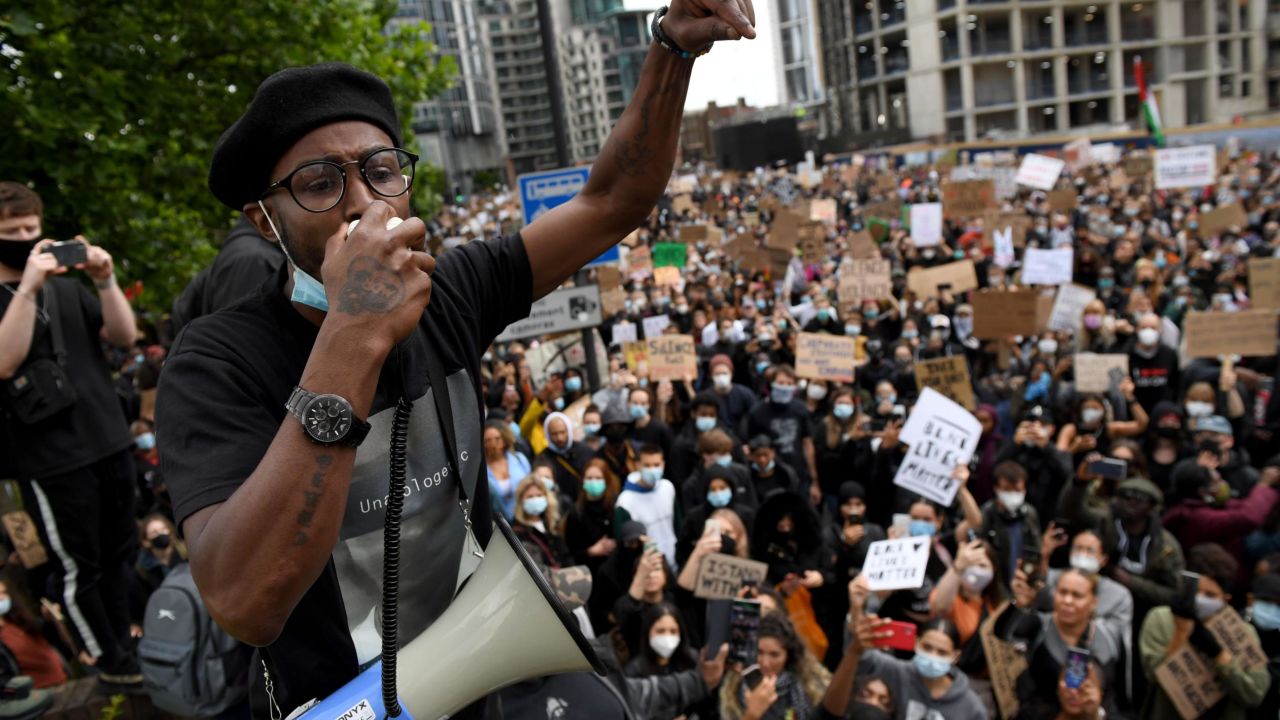 An activist addresses the crowd near the US Embassy in London.
