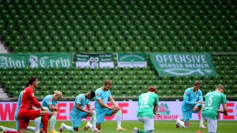 Players from both teams take a knee in protest prior to the Bundesliga match between SV Werder Bremen and VfL Wolfsburg in Germany on Sunday.