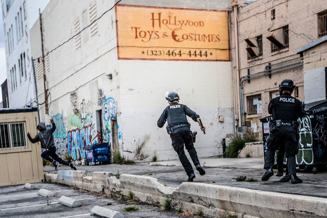 An LAPD officer chases a suspected looter in an alley behind Hollywood Boulevard on June 1.