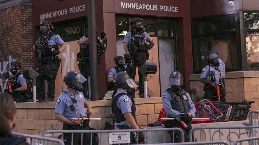 MINNEAPOLIS, USA - MAY 27: Police stand guard at protestors from the roof of the 3rd precinct on Wednesday, May 27, 2020, during the second day of protests over the death of George Floyd in Minneapolis. Floyd died in police custody in Minneapolis on Monday night, after an officer held his knee into Floyd's neck for more than 5 minutes. (Photo by Jordan Strowder/Anadolu Agency via Getty Images)