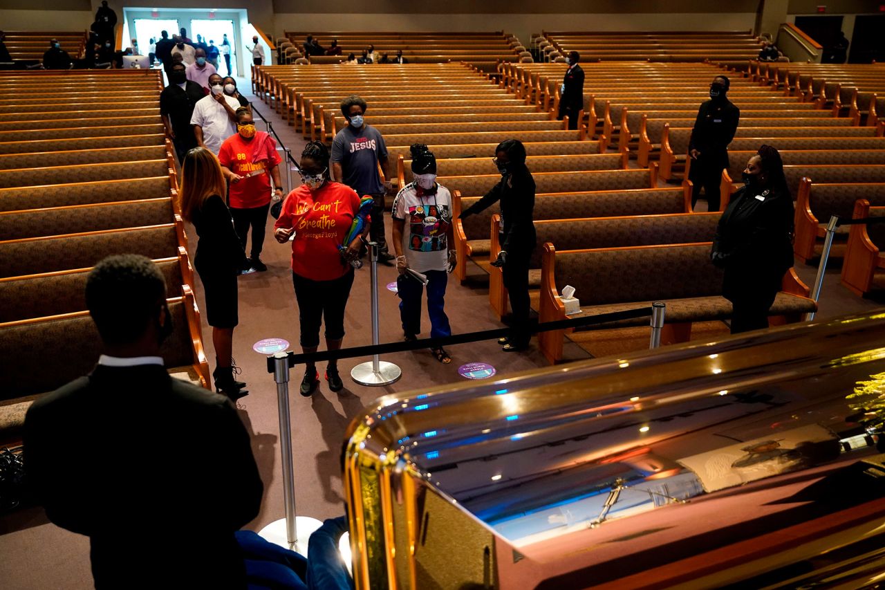 Ushers guide mourners into the church for Floyd's public visitation in Houston.