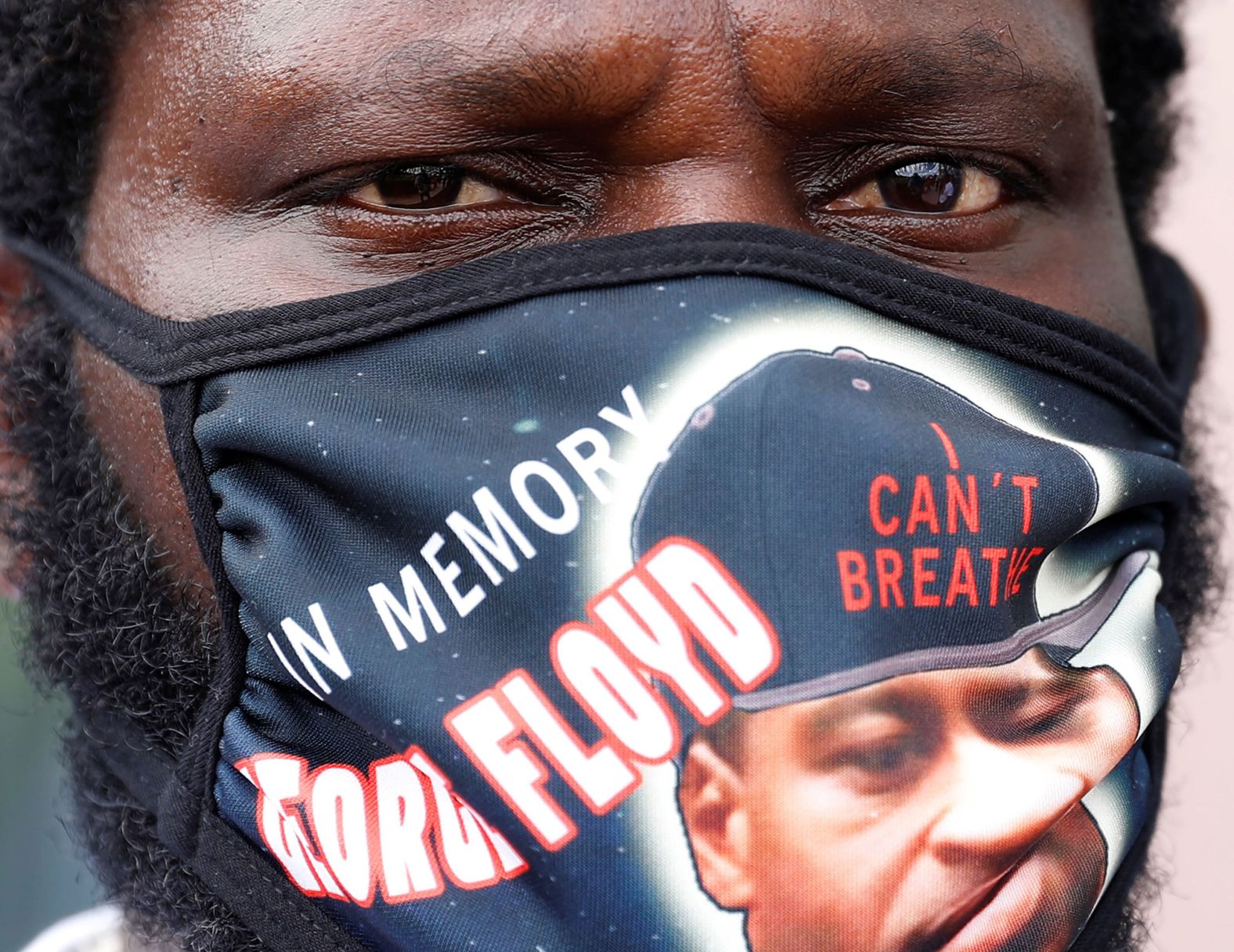 A man in Houston wears a mask honoring Floyd.