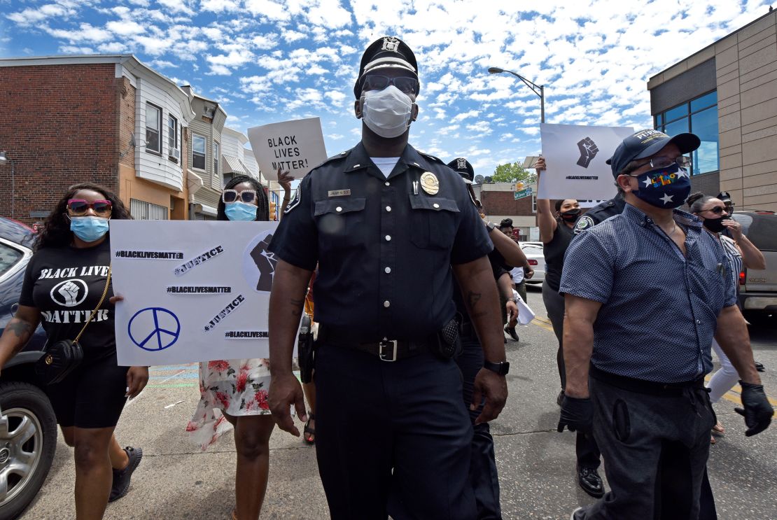 Lt. Zack James of the Camden County Metro Police Department marches along with demonstrators in Camden.