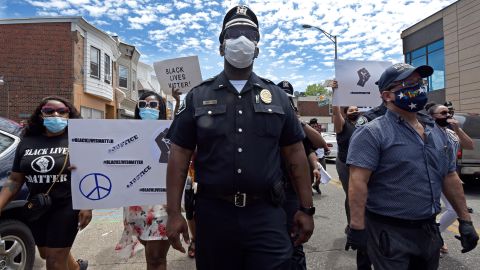 Lt. Zack James of the Camden County Metro Police Department marches along with demonstrators in Camden. 