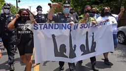 Camden County Metro Police Chief Joe Wysocki raises a fist while marching with residents and activists in Camden, New Jersey. His department was created seven years ago after the city's original police department was disbanded due to corruption. 
