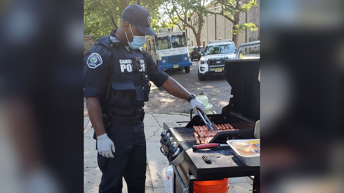 A Camden County officer grills hot dogs for one of the department's pop-up neighborhood parties. 