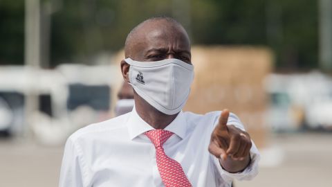 Haitian President Jovenel Moise instructs staff members on the tarmac of  Toussaint Louverture International Airport in Port-au-Prince on May 7, 2020, as coronavirus aid from China arrives in a cargo plane. 