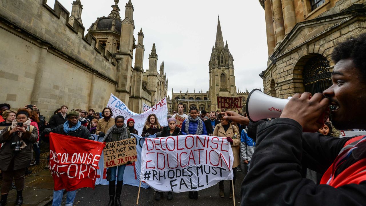 Students demonstrate outside Oxford University's All Souls College where a staute of Christopher Codrington is based which they are campaigning to be removed from the building on March 9, 2016 in Oxford, England. The demonstrators are calling for statues of colonial era figures including Cecil Rhodes and Queen Victoria to removed from university campuses. Cecil Rhodes was a british businessman and politician in South Africa, who served as Prime Minister of the Cape Colony from 1890 to 1896.  