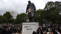 LONDON, UNITED KINGDOM - JUNE 07: Protesters gather in Parliament Square Garden around the statue of Winston Churchill which has graffiti with the words "was a racist" outside the Houses of Parliament in Westminster during a Black Lives Matter protest on June 07, 2020 in London, United Kingdom. The death of an African-American man, George Floyd, while in the custody of Minneapolis police has sparked protests across the United States, as well as demonstrations of solidarity in many countries around the world. (Photo by Chris J Ratcliffe/Getty Images)