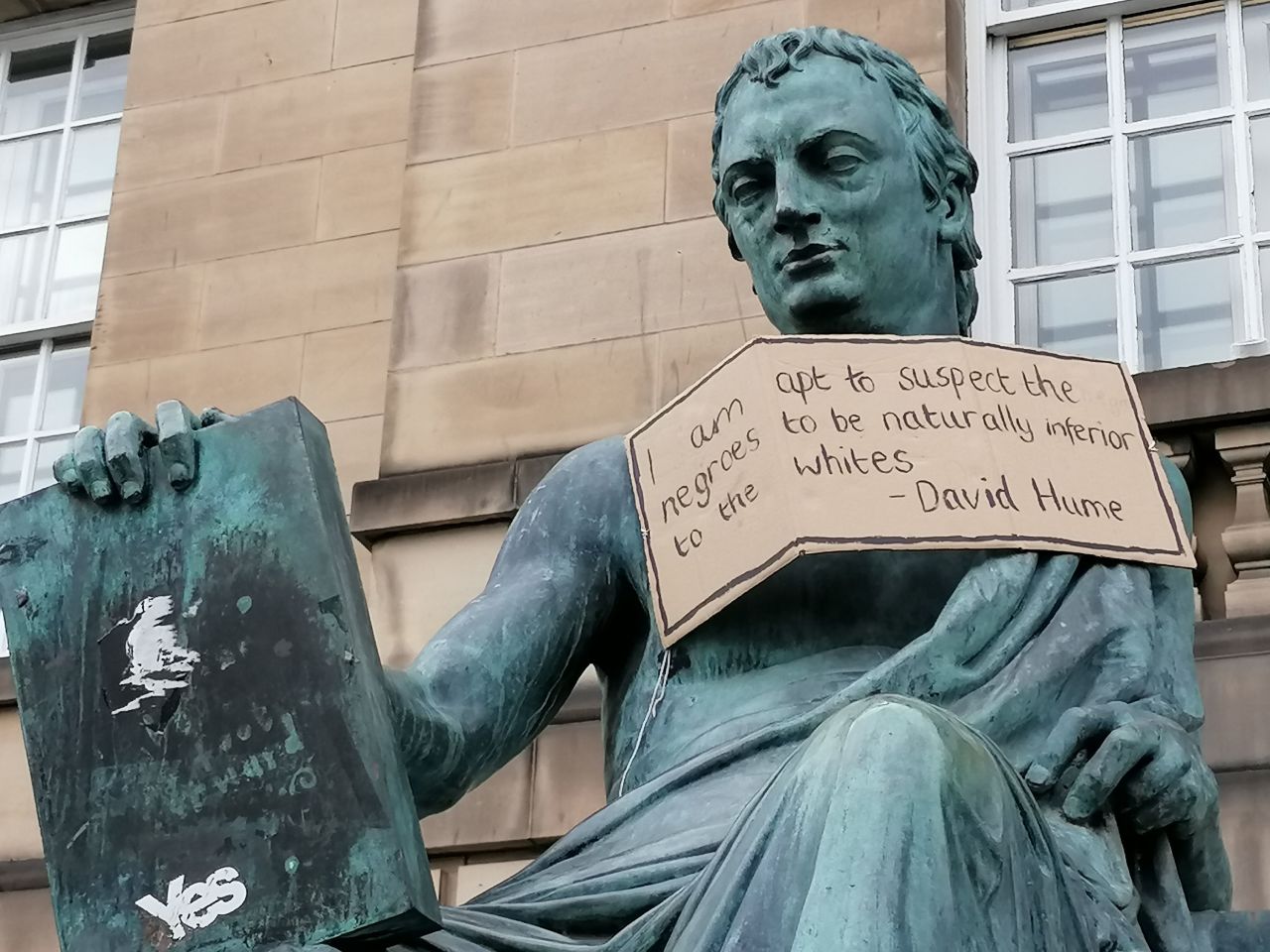A placard was placed in protest on a statue of Scottish Enlightenment philosopher David Hume, decrying his racist views. 