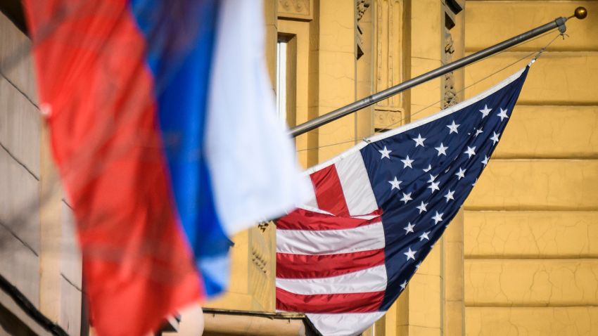 A Russian flag flies next to the US embassy building in Moscow on October 22, 2018. - US national security advisor John Bolton is in Moscow holding meetings with senior Russian officials following Washington's weekend announcement of withdrawal from the Cold War-era Intermediate-Range Nuclear Forces Treaty, known as the INF. (Photo by Mladen ANTONOV / AFP)        (Photo credit should read MLADEN ANTONOV/AFP via Getty Images)