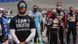 HAMPTON, GEORGIA - JUNE 07: Bubba Wallace, driver of the #43 McDonald's Chevrolet,  wears  a "I Can't Breath - Black Lives Matter" T-shirt under his fire suit in solidarity with protesters around the world taking to the streets after the death of George Floyd on May 25 while in the custody of Minneapolis, Minnesota police, stands during the national anthem prior to the NASCAR Cup Series Folds of Honor QuikTrip 500 at Atlanta Motor Speedway on June 07, 2020 in Hampton, Georgia. (Photo by Chris Graythen/Getty Images)