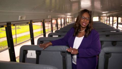 Interim Superintendent Grenita Lathan shows how children will be spaced  while riding buses.