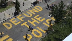 People walk down 16th street after Defund The Police was painted on the street near the White House on June 8, 2020 in Washington, DC.