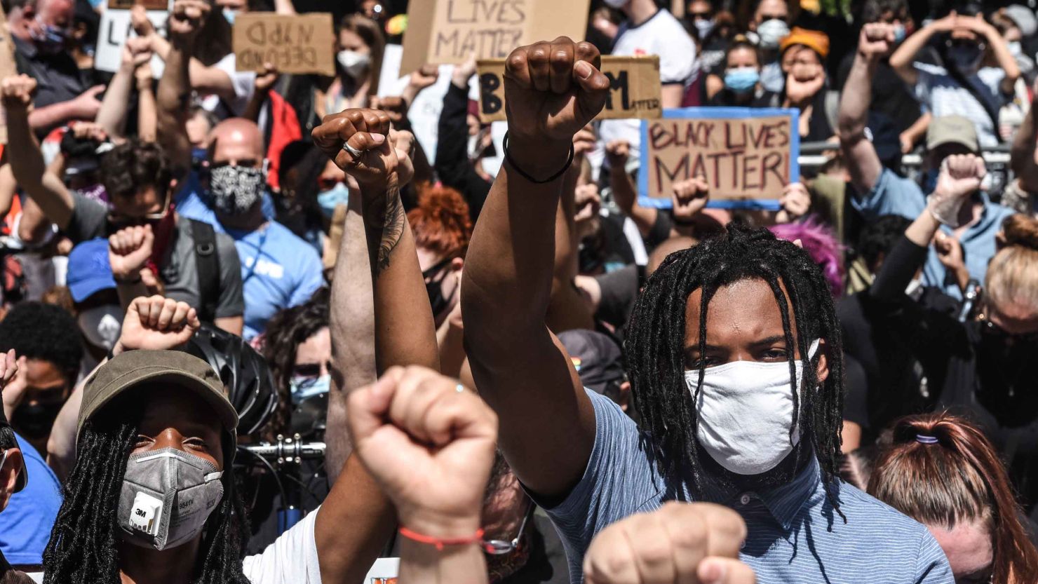 People protest outside of One Police Plaza on June 8. More than 500 former and current mayor's office staff joined in calls for NYPD reforms.